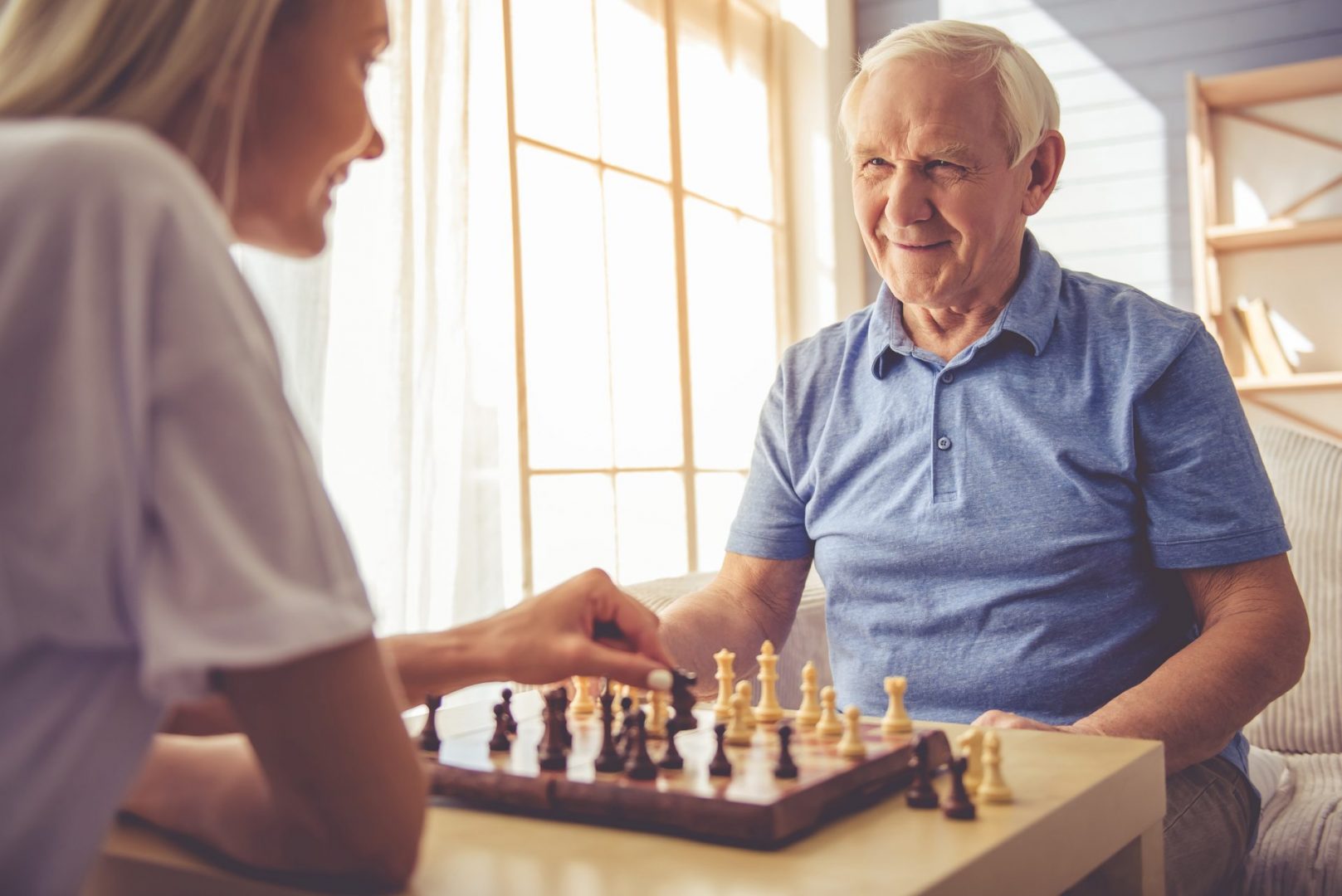 Companion playing chess with elderly patient